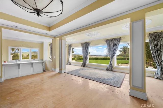 a living room with fireplace furniture and a large window