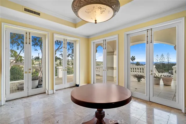 a view of a dining room with furniture and a chandelier