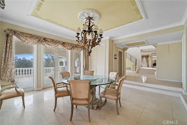 a view of a dining room with furniture wooden floor and chandelier