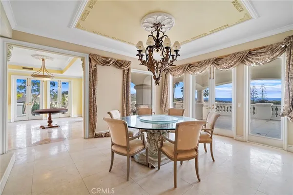 a living room with a table chair and a large window