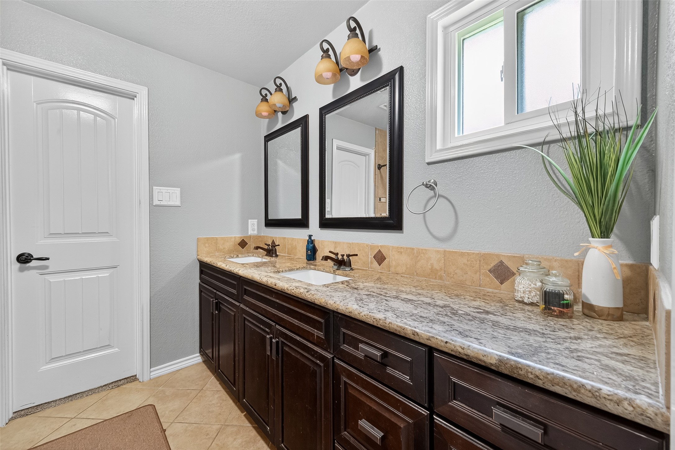 2103 Diane Street Pinehurst, TX 77362 - Photo 12 of 17 a bathroom with a granite countertop sink and a mirror