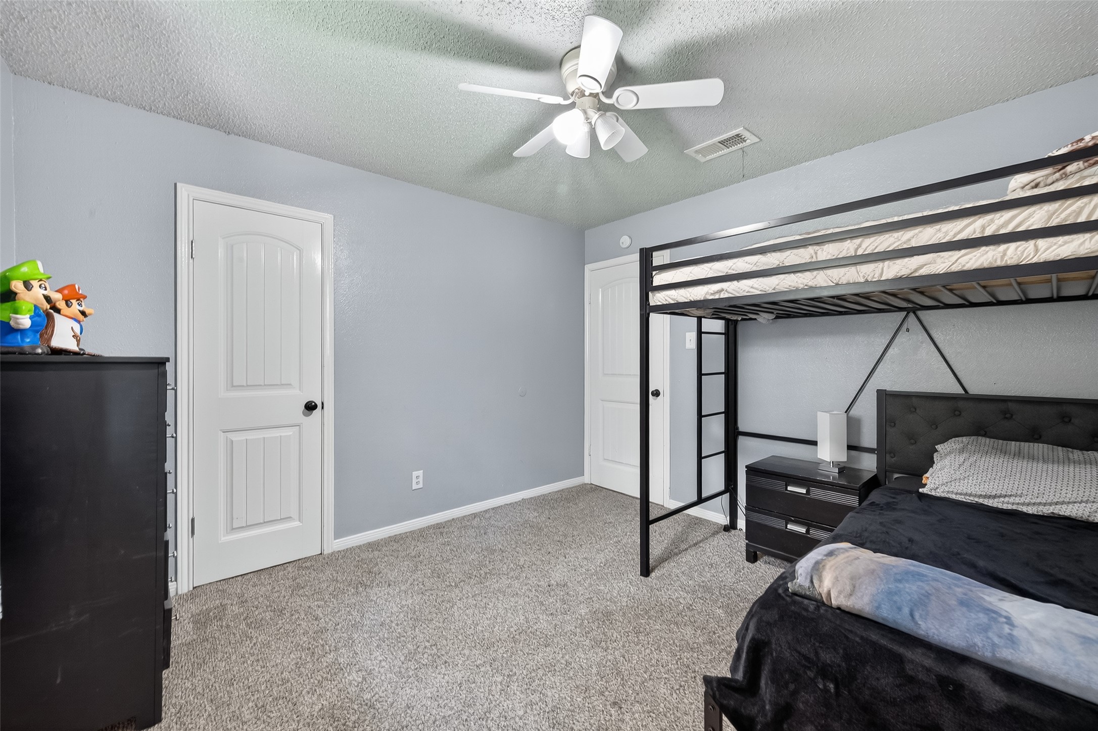 2103 Diane Street Pinehurst, TX 77362 - Photo 15 of 17 a bedroom with a bed and a chandelier