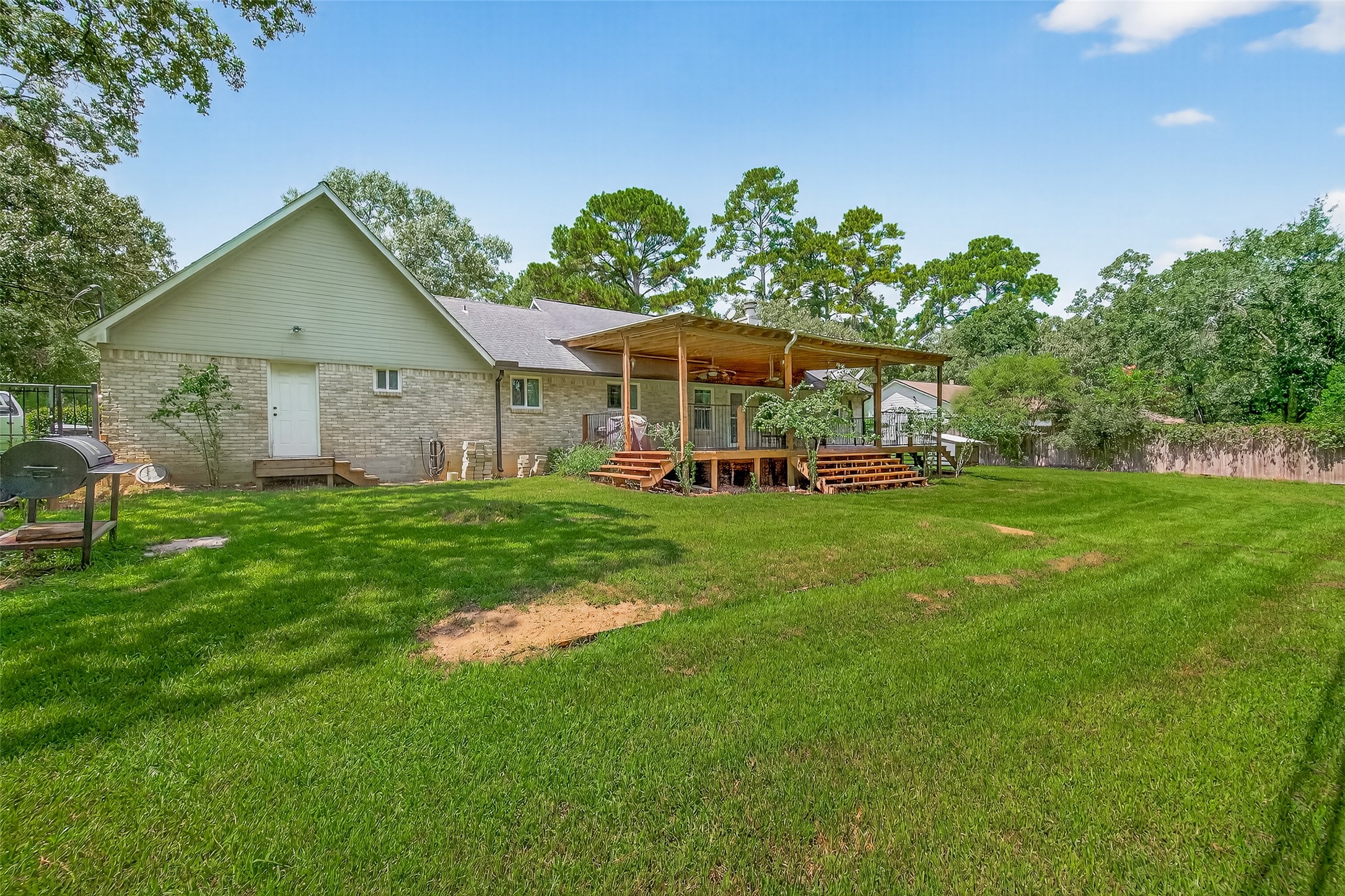 2103 Diane Street Pinehurst, TX 77362 - Photo 17 of 17 a view of a house with a big yard potted plants and large tree