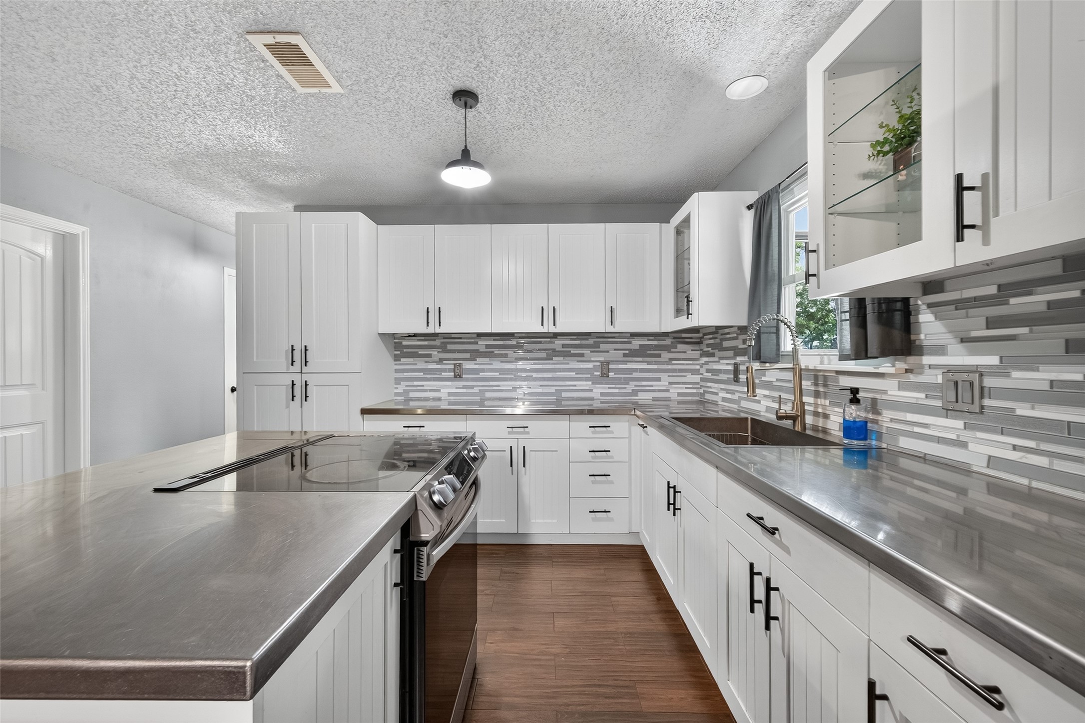 2103 Diane Street Pinehurst, TX 77362 - Photo 6 of 17 a kitchen with stainless steel appliances granite countertop a sink a stove and cabinets