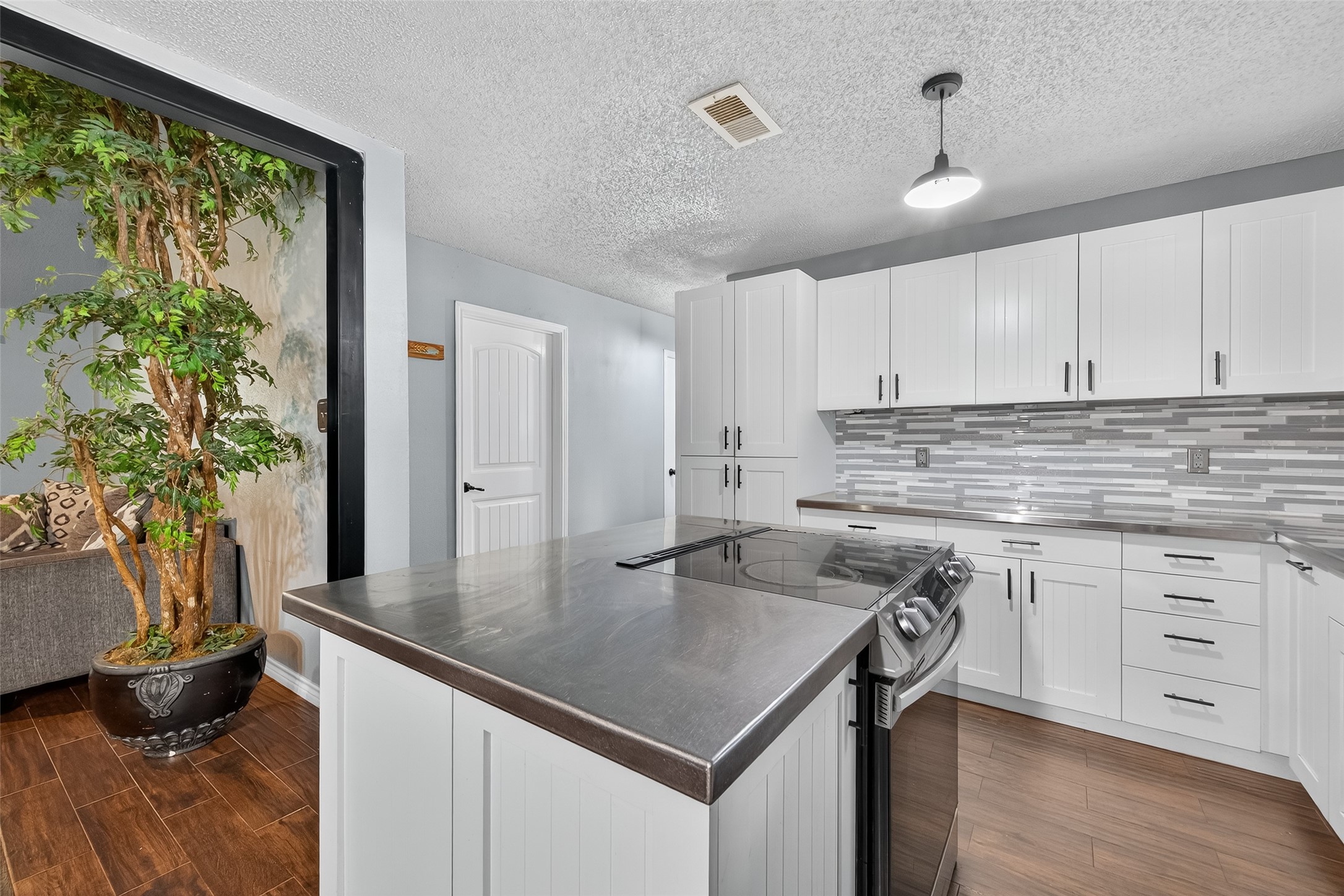 2103 Diane Street Pinehurst, TX 77362 - Photo 7 of 17 a kitchen with stainless steel appliances granite countertop a sink a stove and a wooden cabinets