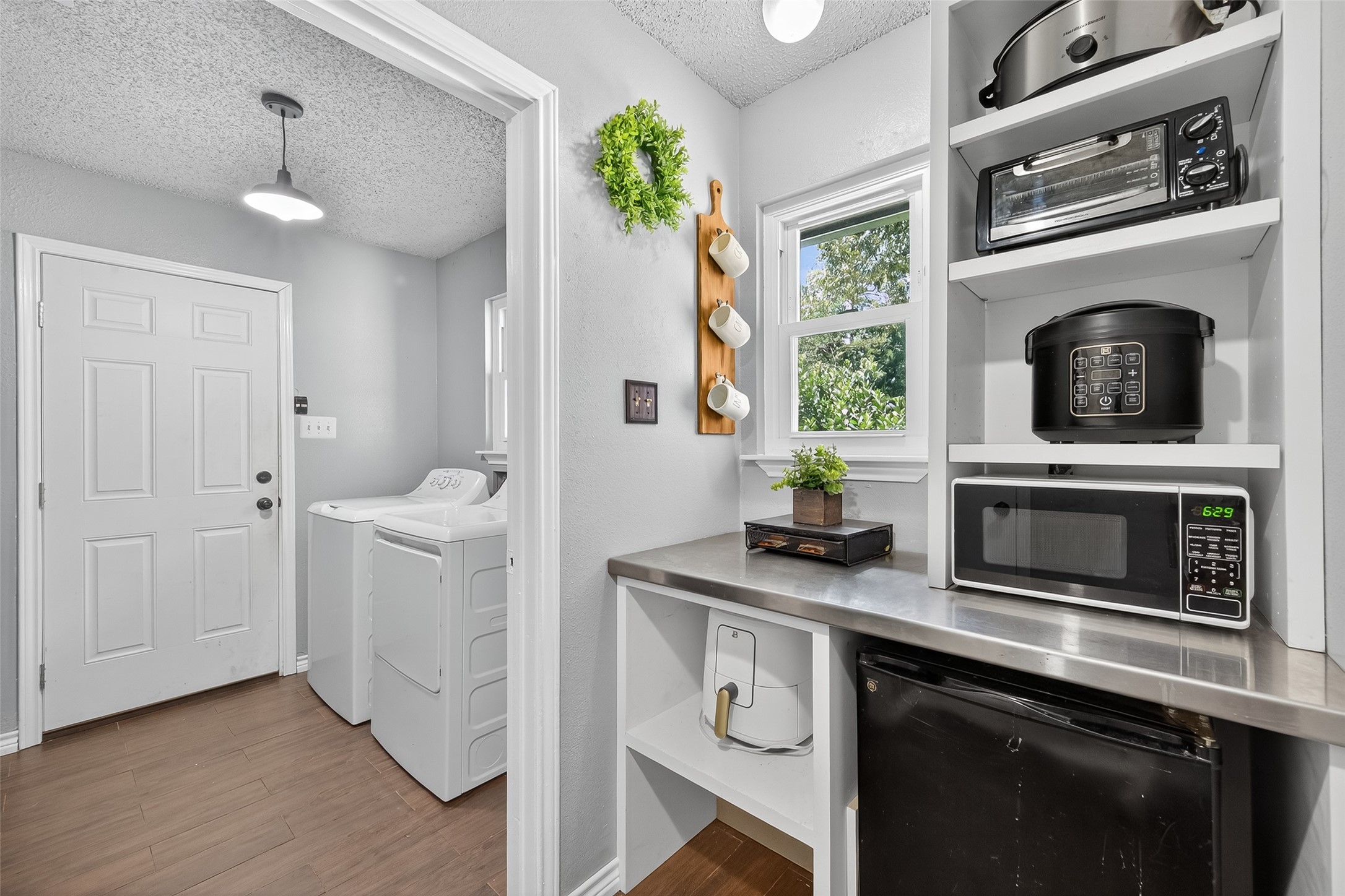 2103 Diane Street Pinehurst, TX 77362 - Photo 9 of 17 a kitchen with stainless steel appliances a stove a microwave and a hard wood floors