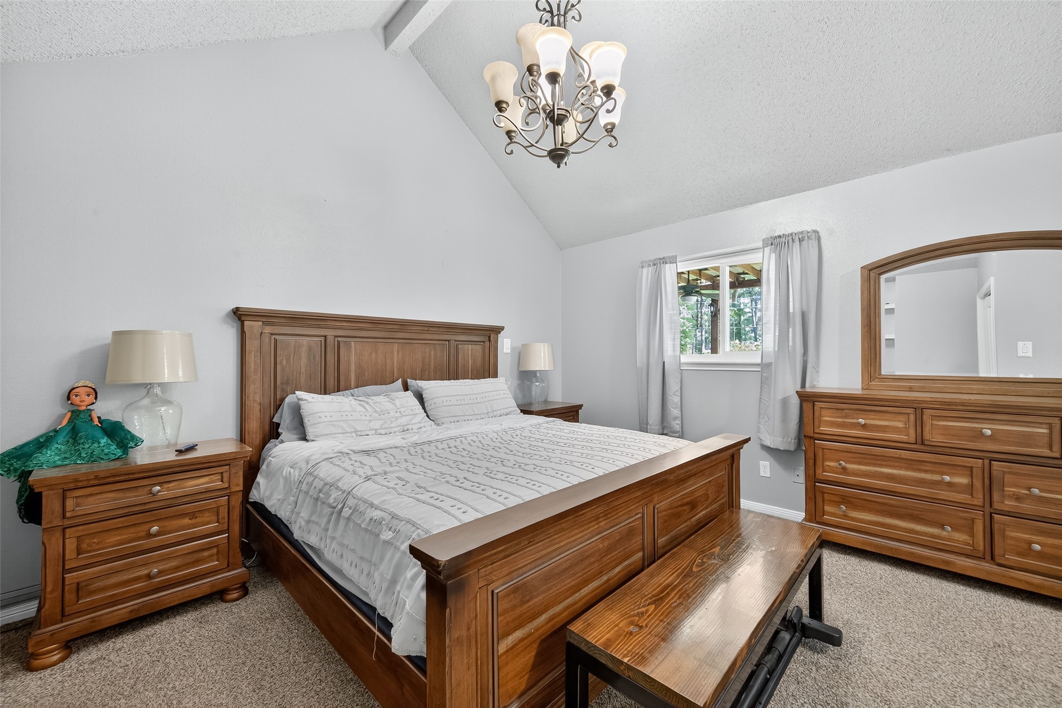 2103 Diane Street Pinehurst, TX 77362 - Photo 10 of 17 a bedroom with a bed and a chandelier