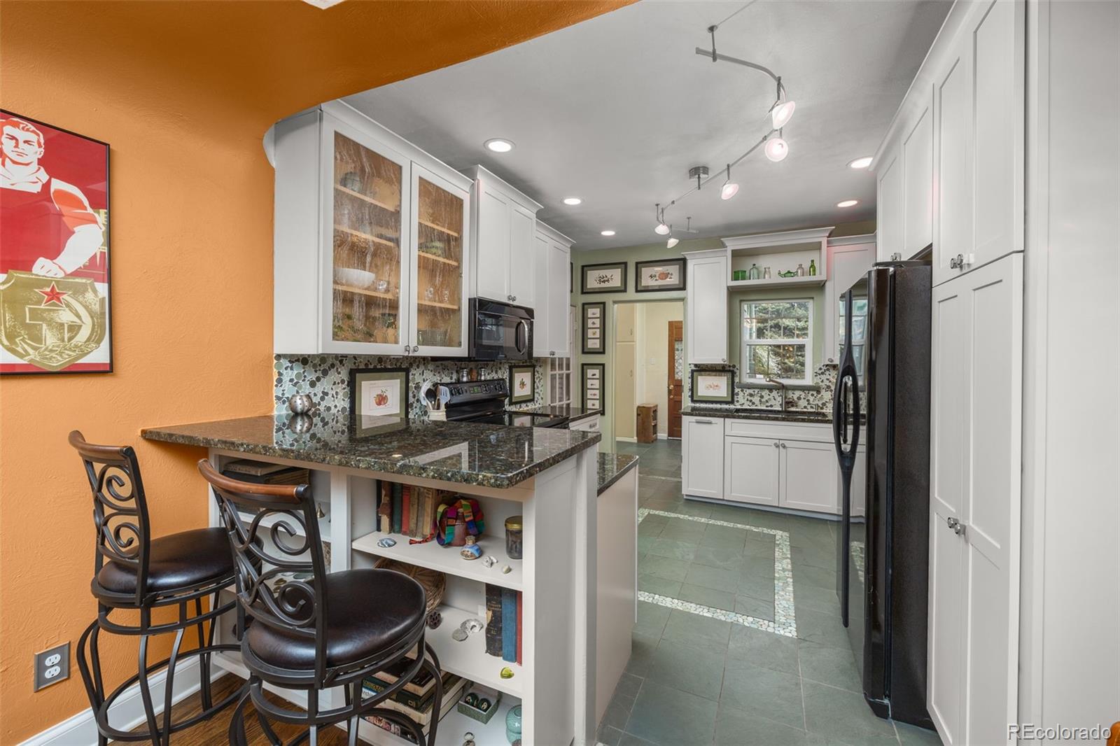 2514 Humboldt Street Denver, CO 80205 - Photo 12 of 39 a kitchen with kitchen island stainless steel appliances a sink stove and refrigerator