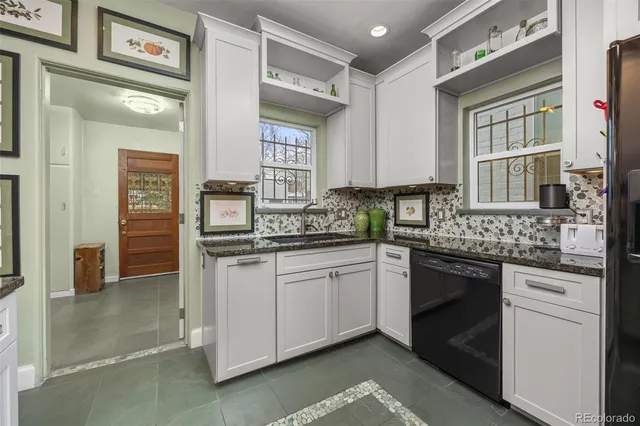 a living room with furniture a rug and a bookshelf