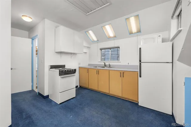 an empty room with windows and flowerpot