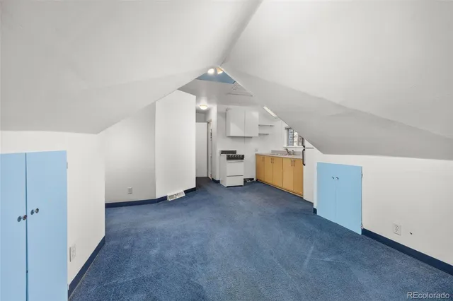 a view of an empty room with stairs and white walls