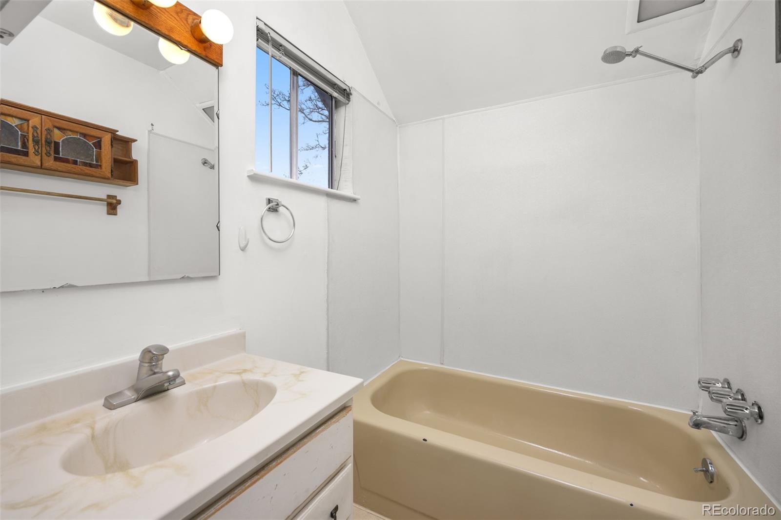 2514 Humboldt Street Denver, CO 80205 - Photo 30 of 39 a bathroom with a sink and a bathtub