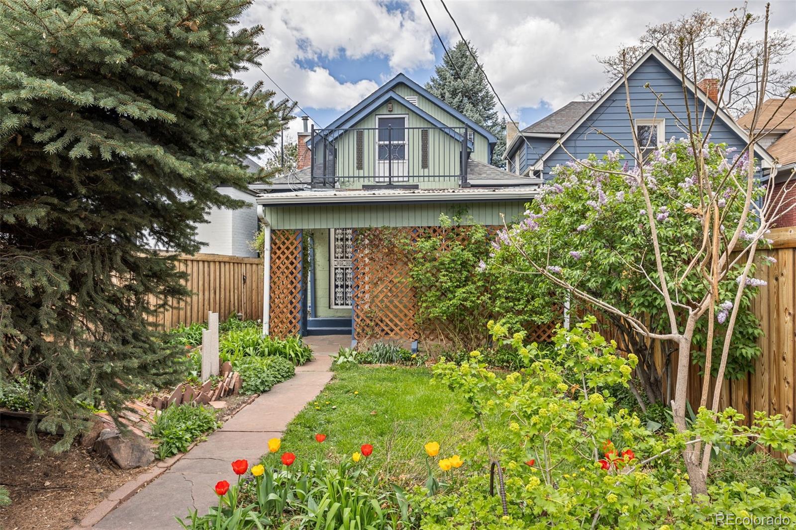 2514 Humboldt Street Denver, CO 80205 - Photo 3 of 39 a front view of a house with a garden
