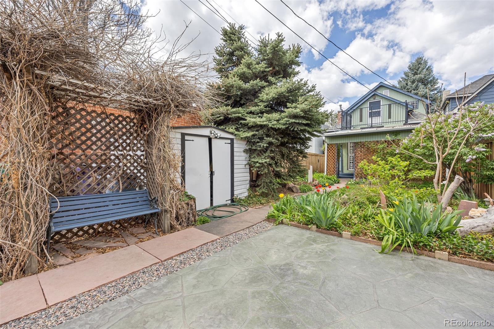 2514 Humboldt Street Denver, CO 80205 - Photo 36 of 39 a house with a bench and potted plants
