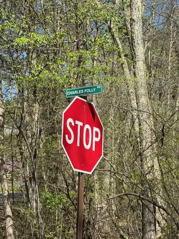a blue sign that is sitting next to a road