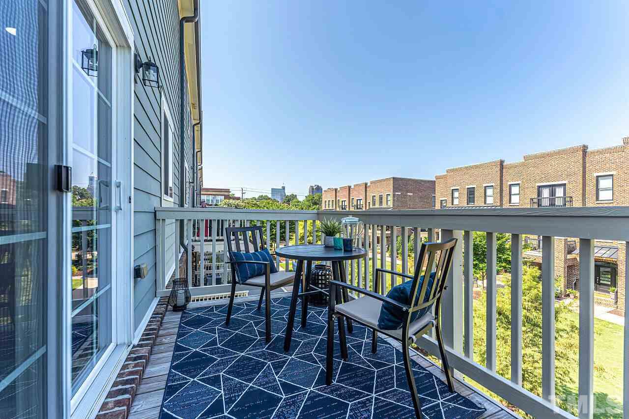 511 North Person Street, Unit 207 Raleigh, NC 27604 - Photo 17 of 17 Deck off kitchen overlooks green space with view of Raleigh skyline.