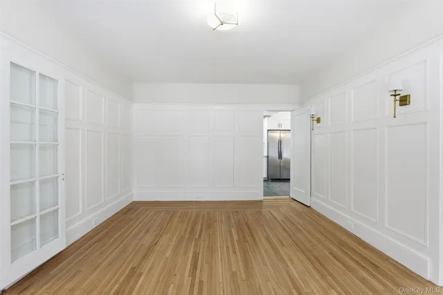 a view of a room with wooden floor and a bathroom