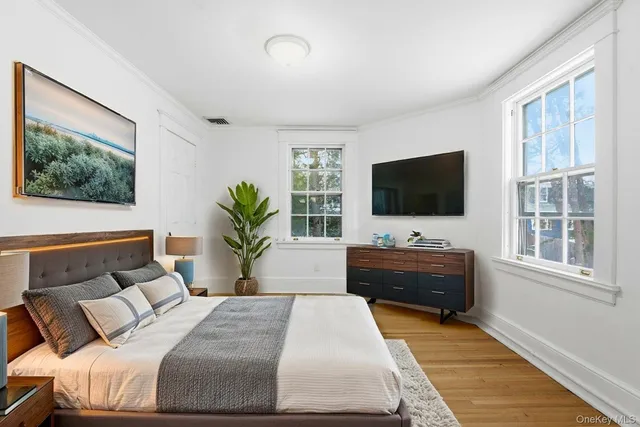 a bedroom with a bed and a flat screen television
