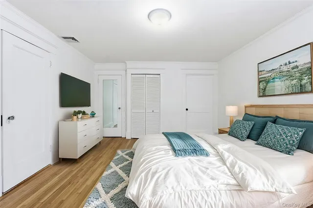 a bedroom with a flat screen tv and a bed