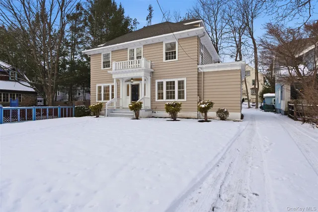 a view of a house with a snow on the road