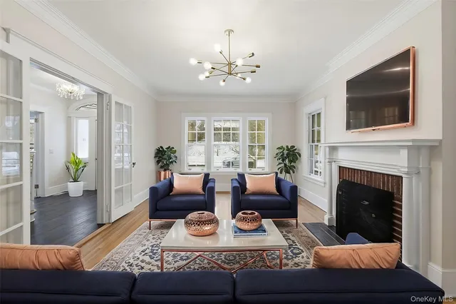 a living room with furniture a fireplace and a flat screen tv