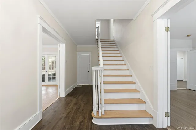 a view of an entryway with wooden floor