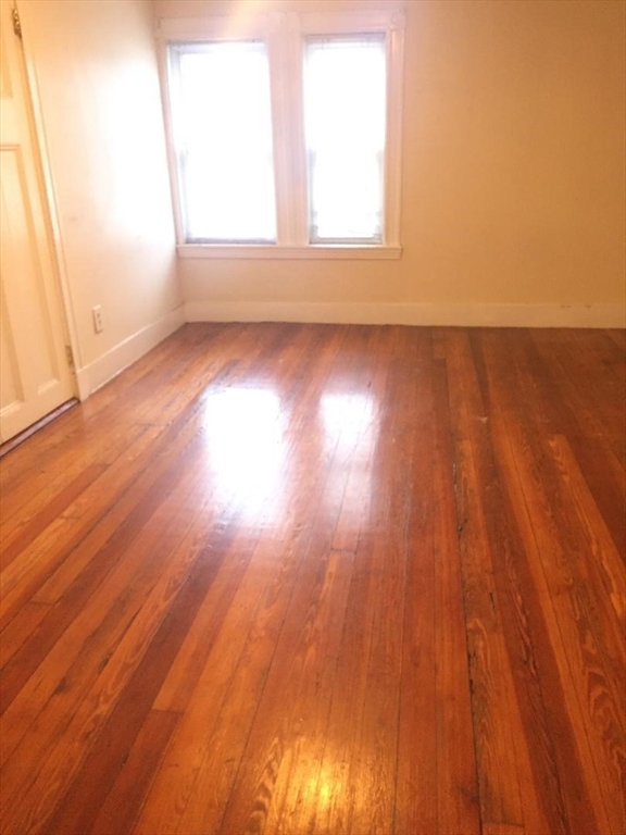 139 South Street, Unit 3 Waltham, MA 02453 - Photo 1 of 3 an empty room with wooden floor and windows