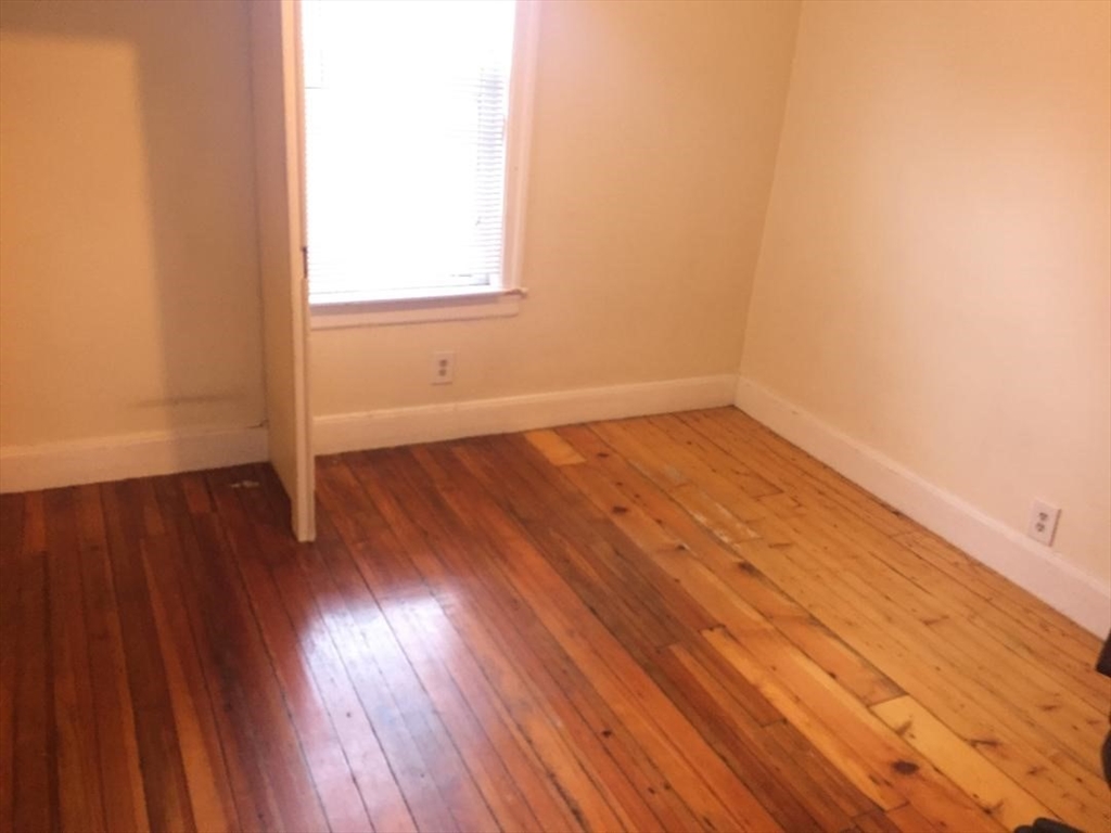 139 South Street, Unit 3 Waltham, MA 02453 - Photo 2 of 3 an empty room with wooden floor and windows