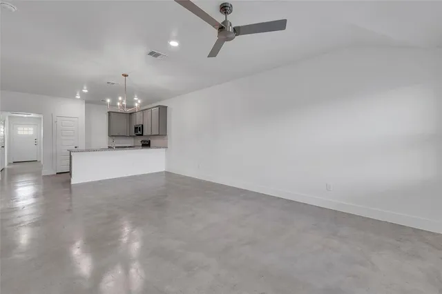 a view of a kitchen with a sink and a fireplace