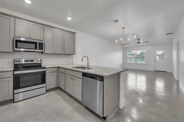 a kitchen with a sink stove and microwave