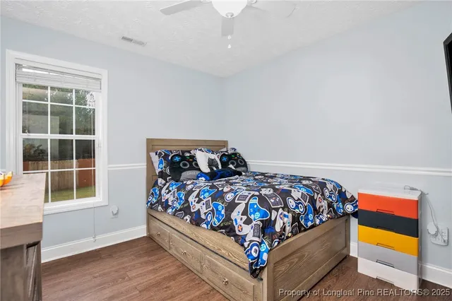 a bed sitting in a bedroom next to a window