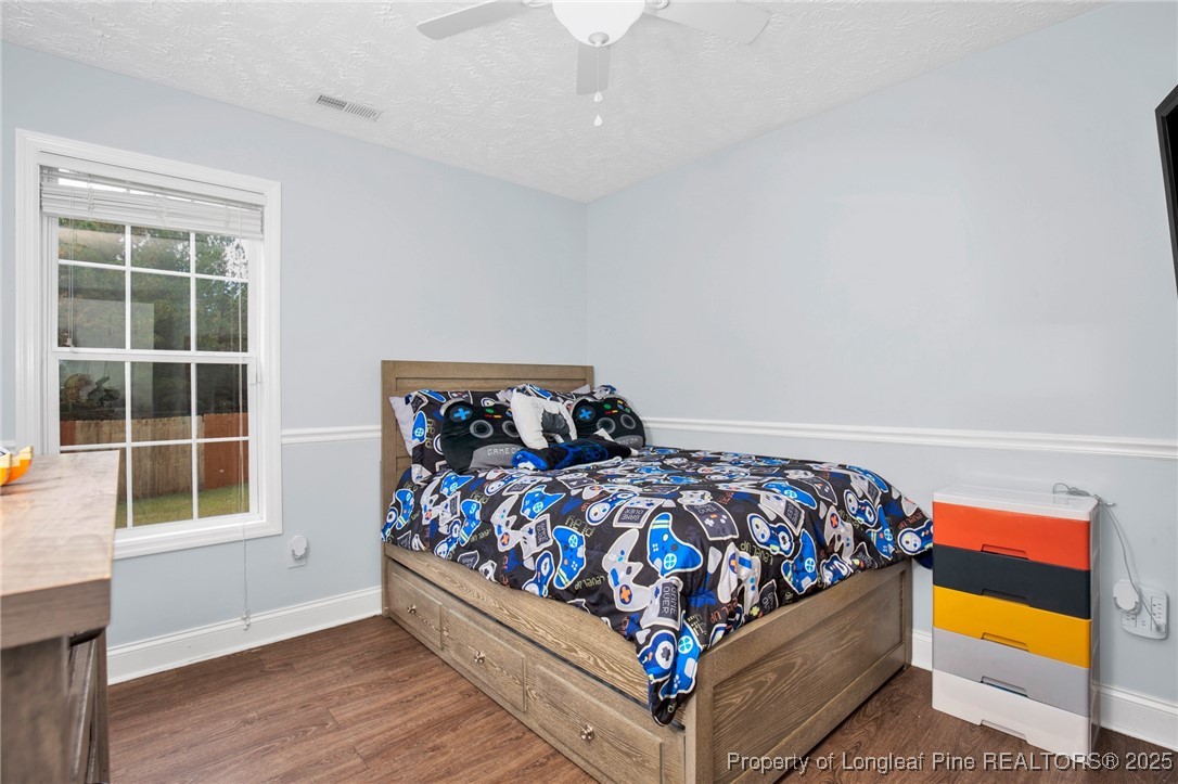674 Copper Creek Drive Raeford, NC 28376 - Photo 12 of 20 a bed sitting in a bedroom next to a window