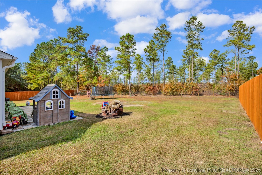 674 Copper Creek Drive Raeford, NC 28376 - Photo 18 of 20 a front view of a house with garden