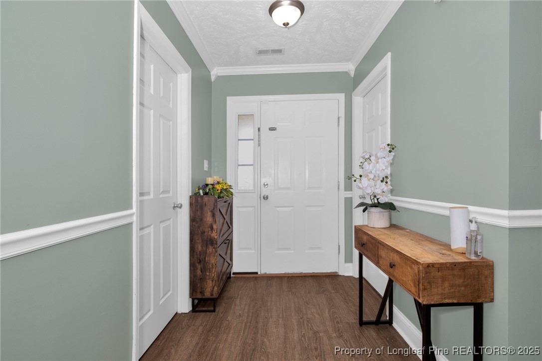 674 Copper Creek Drive Raeford, NC 28376 - Photo 4 of 20 a hallway with chairs and wooden floor