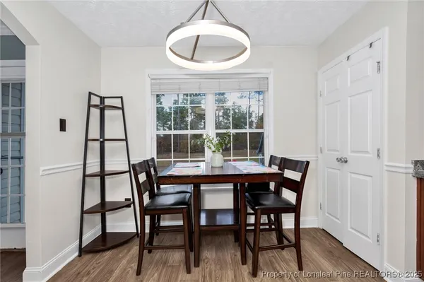 a view of a dining room with furniture and wooden floor