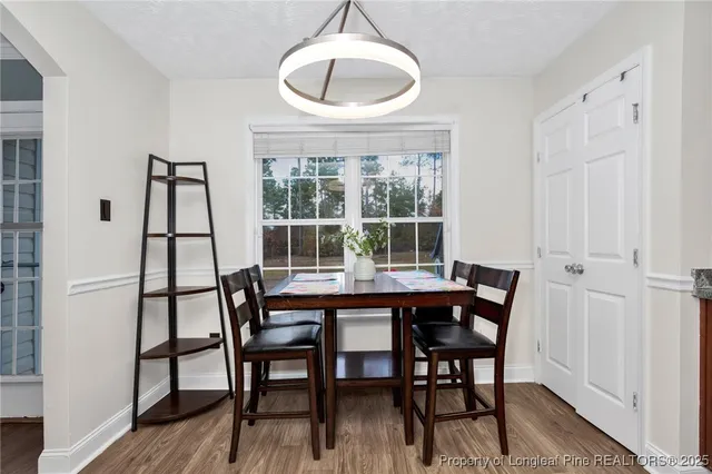 a view of a dining room with furniture and wooden floor