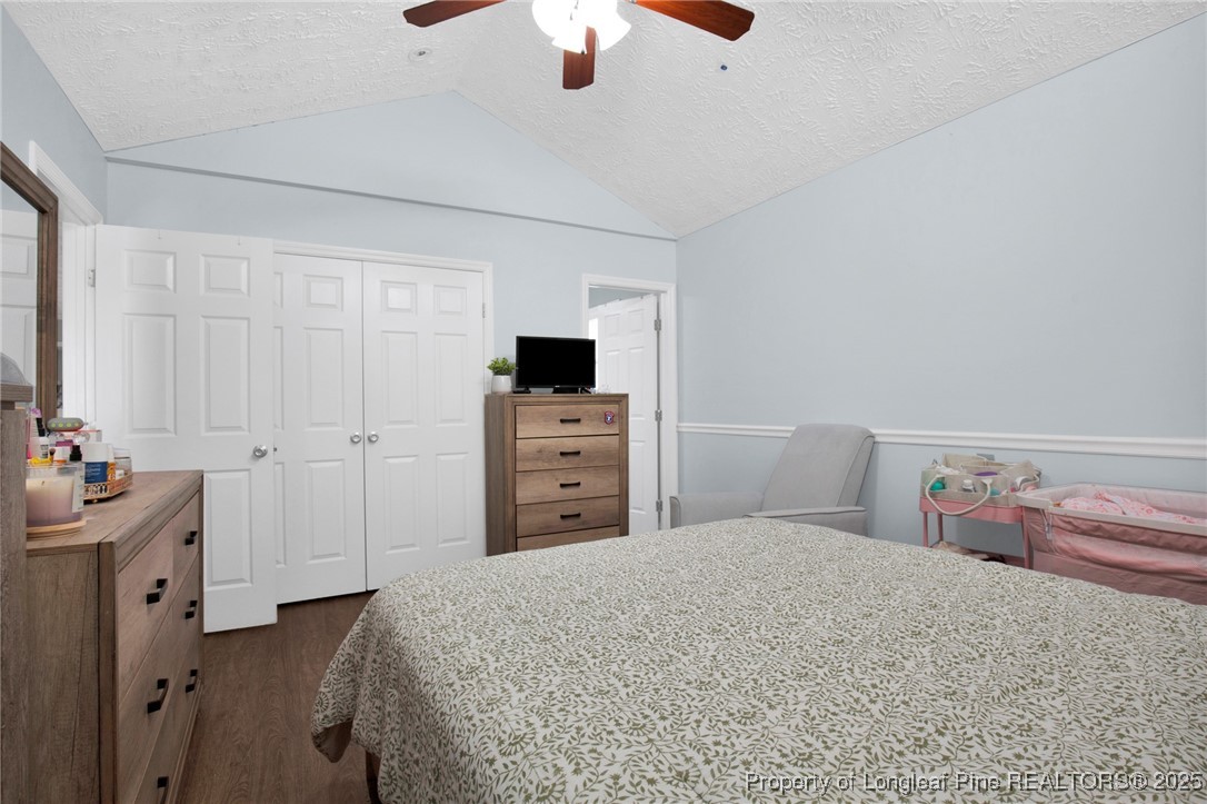 674 Copper Creek Drive Raeford, NC 28376 - Photo 10 of 20 a bedroom with a bed and a chandelier