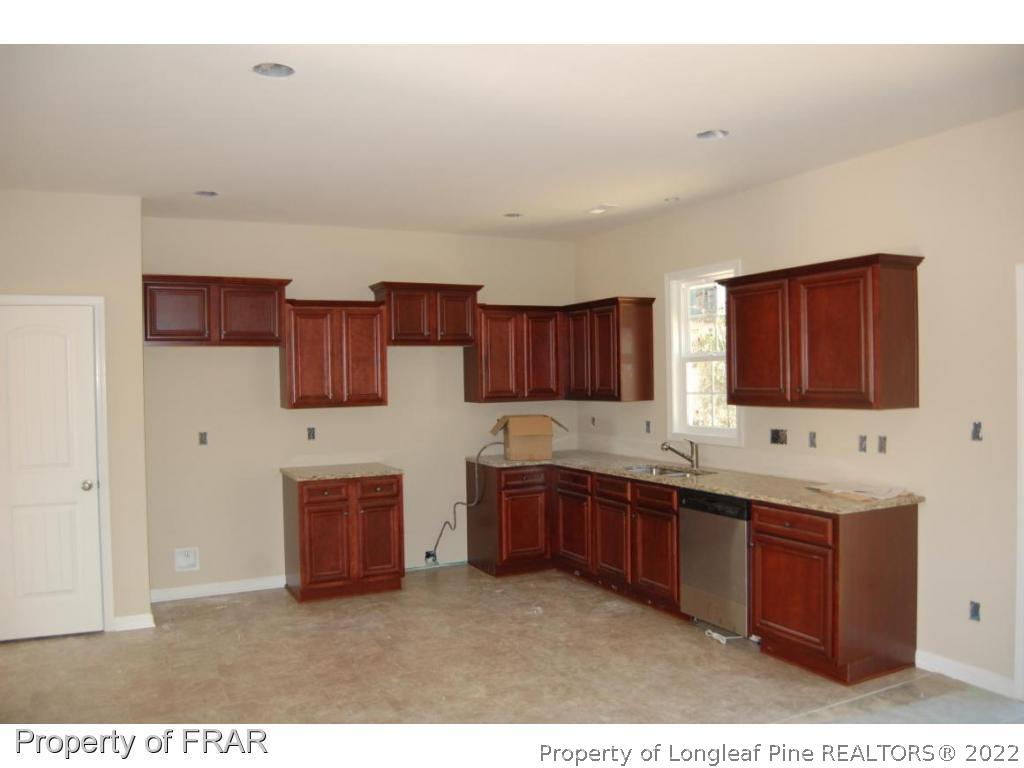11 Rockingham Street Spring Lake, NC 28390 - Photo 2 of 14 a kitchen with stainless steel appliances granite countertop a sink stove and cabinets