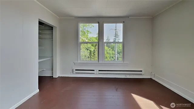 a view of a room with window and wooden floor