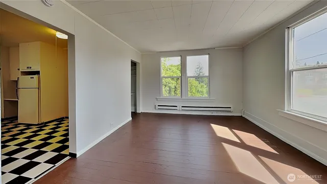 a kitchen with a checkered floor and white cabinets