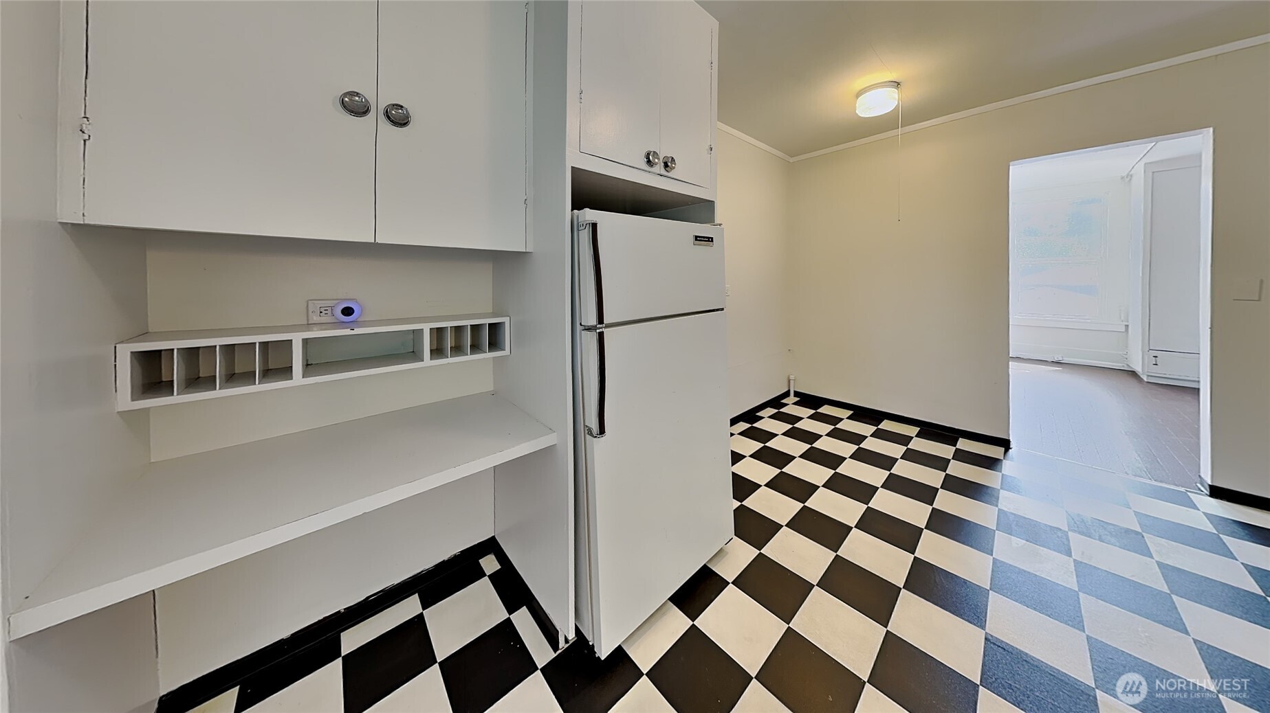 4700 Southwest Othello Street Seattle, WA 98136 - Photo 14 of 17 a kitchen with a checkered floor and white cabinets