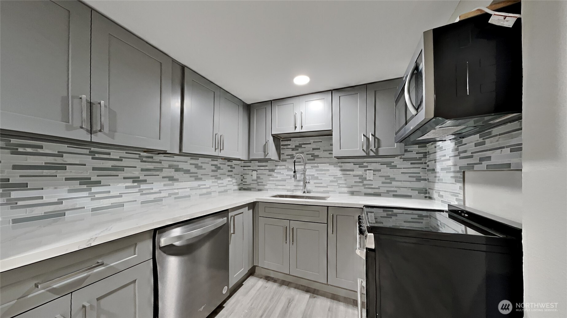 4700 Southwest Othello Street Seattle, WA 98136 - Photo 15 of 17 a kitchen with stainless steel appliances granite countertop a sink stove and cabinets