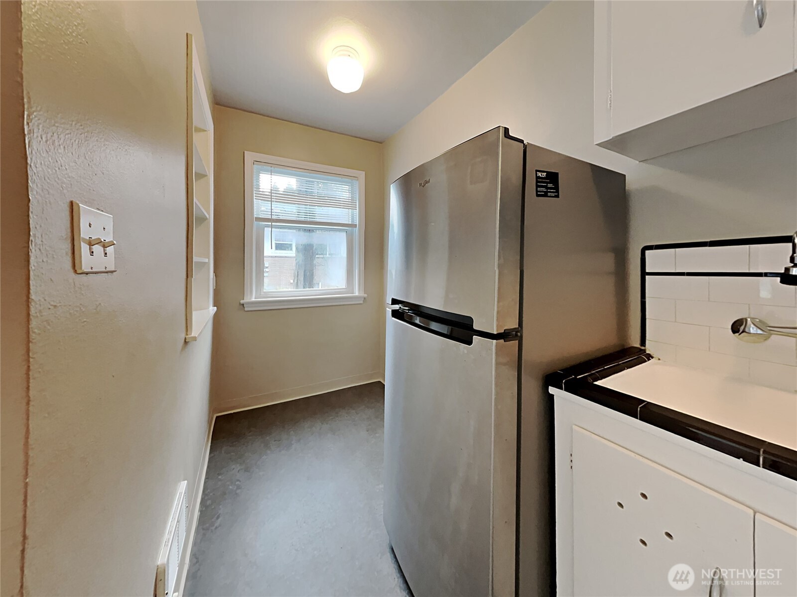 4700 Southwest Othello Street Seattle, WA 98136 - Photo 8 of 17 a kitchen with a refrigerator and a sink