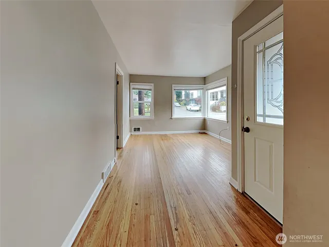 a view of a room with wooden floor and cabinet