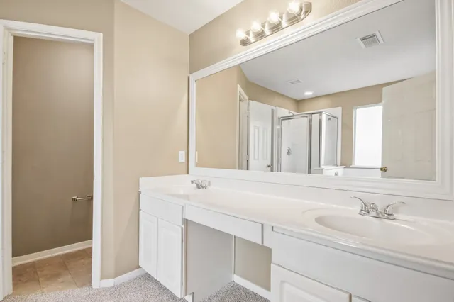 a bathroom with a sink double vanity and a mirror