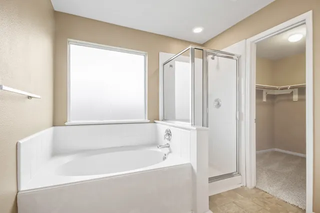 a bathroom with a bathtub and a shower
