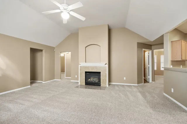 a view of a livingroom with a fireplace and window