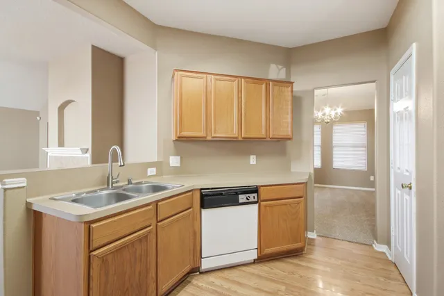a kitchen with a sink cabinets and appliances