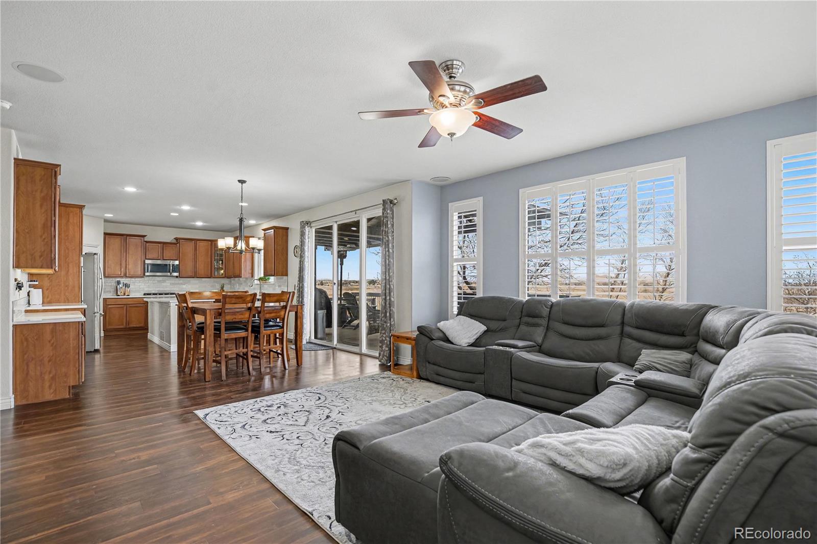 10871 Chambers Way Commerce City, CO 80022 - Photo 12 of 50 a living room with furniture kitchen view and a large window