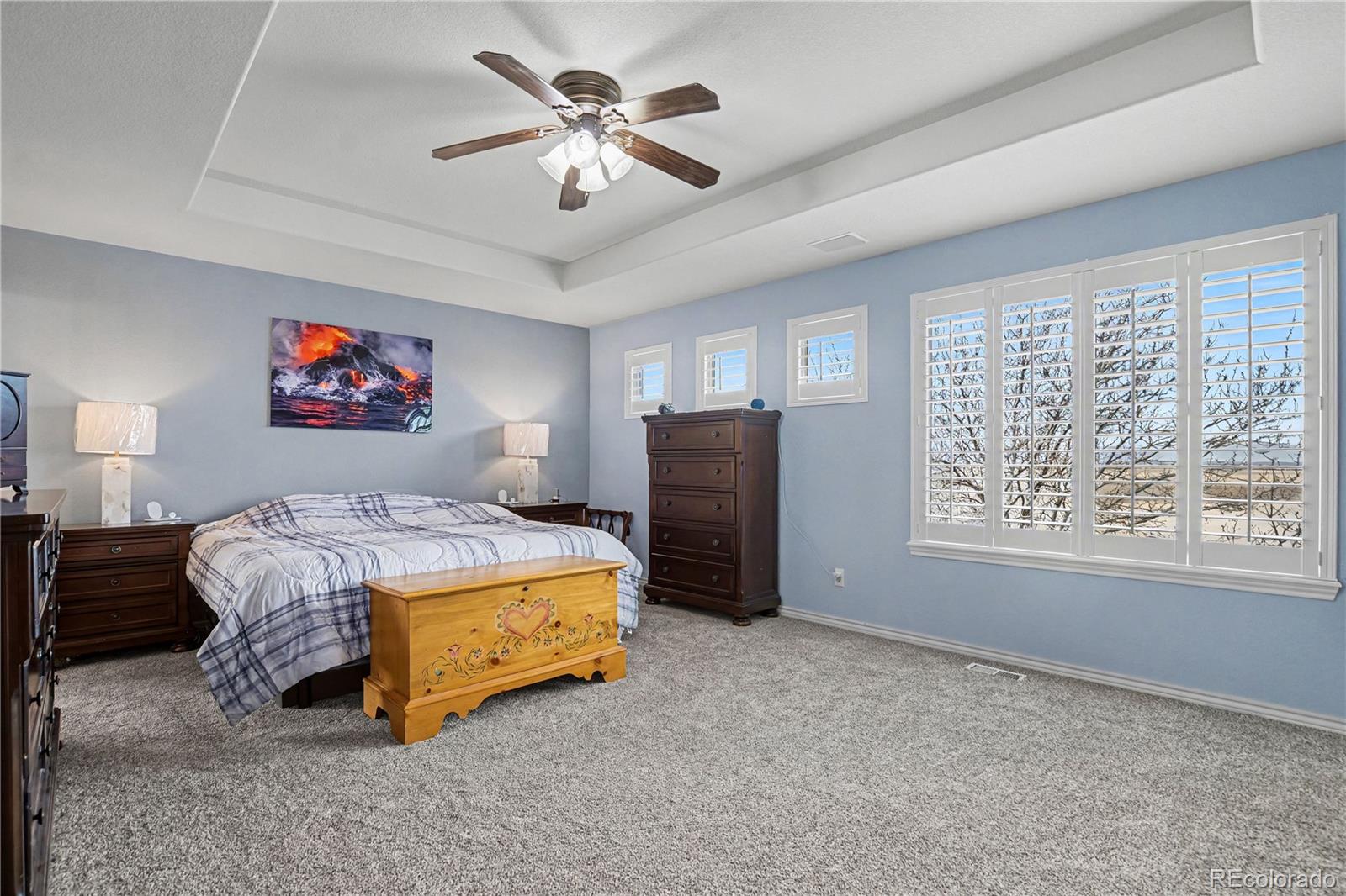 10871 Chambers Way Commerce City, CO 80022 - Photo 18 of 50 a spacious bedroom with a bed and a chandelier
